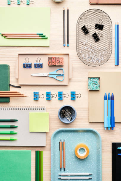 Flat lay of various colorful stationery placed in order on desk in office