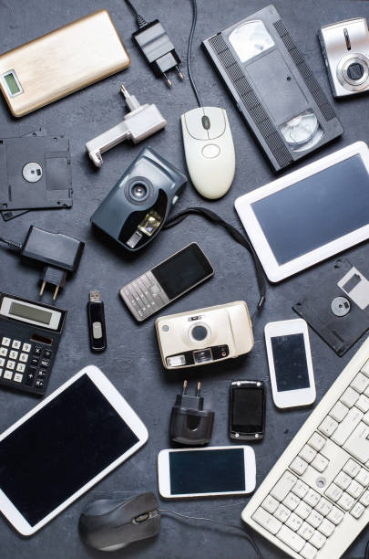 Old electronic devices on a dark background. The concept of recycling and disposal of electronic waste